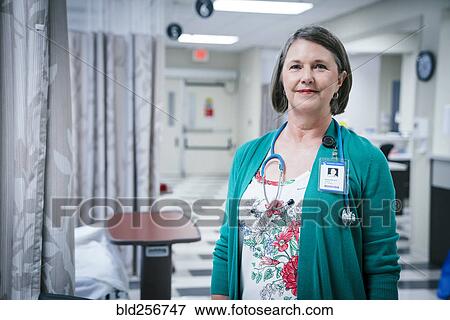 Stock Photo - Portrait of smiling Caucasian doctor in hospital. Fotosearch