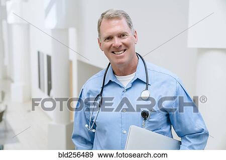 Stock Photo - Portrait of smiling Caucasian doctor. Fotosearch