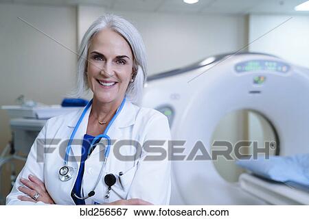 Portrait of smiling Caucasian doctor near scanner View Large Photo Image Stock Photo - Portrait of smiling Caucasian doctor near scanner. Fotosearch