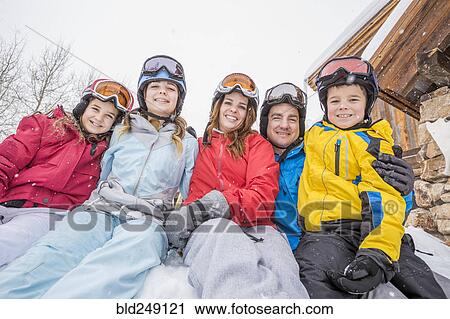 Stock Image - Portrait of smiling Caucasian family on winter vacation. Fotosearch