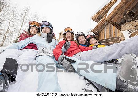 Stock Image - Portrait of smiling Caucasian family on winter vacation. Fotosearch