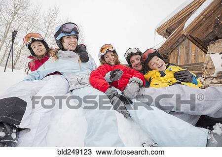 Stock Image - Portrait of smiling Caucasian family on winter vacation. Fotosearch