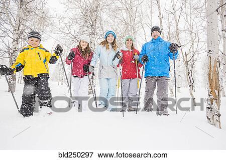 Stock Photo - Portrait of smiling Caucasian family snowshoeing. Fotosearch