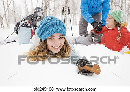 Portrait of smiling Caucasian girl falling in snow View Large Photo Image Stock Photo - Portrait of smiling Caucasian girl falling in snow. Fotosearch