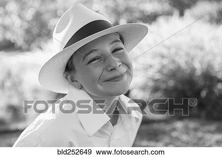 Stock Photo - Portrait of smiling Caucasian girl wearing a fedora. Fotosearch