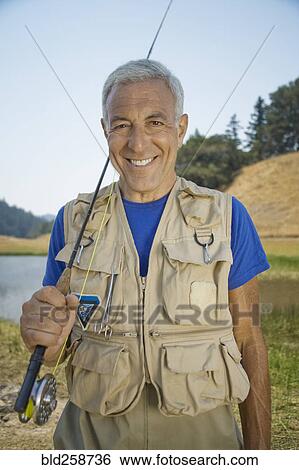 Portrait of smiling Caucasian man holding fishing rod View Large Photo Image Stock Photograph - Portrait of smiling Caucasian man holding fishing rod. Fotosearch