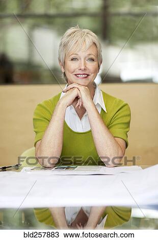 Stock Image - Portrait of smiling Caucasian businesswoman. Fotosearch