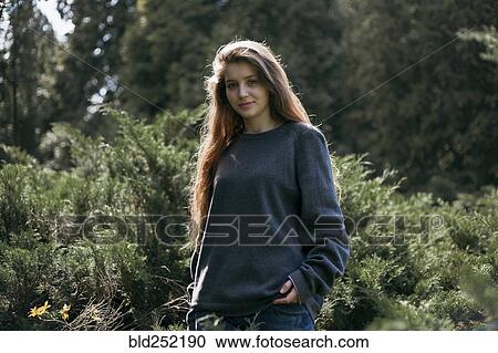Portrait of smiling Caucasian teenage girl in woods View Large Photo Image Stock Image - Portrait of smiling Caucasian teenage girl in woods. Fotosearch