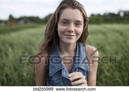 Portrait of smiling Caucasian woman in field View Large Photo Image Stock Photo - Portrait of smiling Caucasian woman in field. Fotosearch