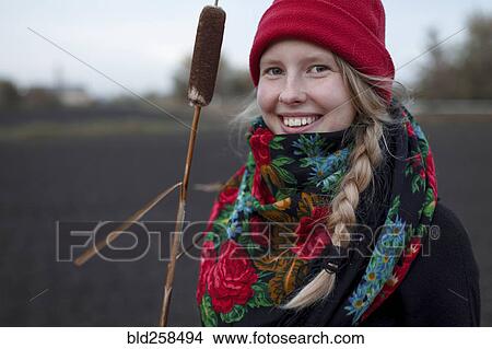 Picture - Portrait of smiling Caucasian woman wearing scarf and stocking-cap. Fotosearch