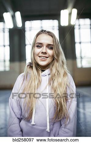 Stock Photo - Portrait of smiling Caucasian woman wearing hoodie. Fotosearch