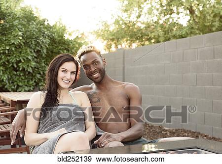 Portrait of smiling couple wrapped in towels near fire pit View Large Photo Image Stock Photo - Portrait of smiling couple wrapped in towels near fire pit. Fotosearch