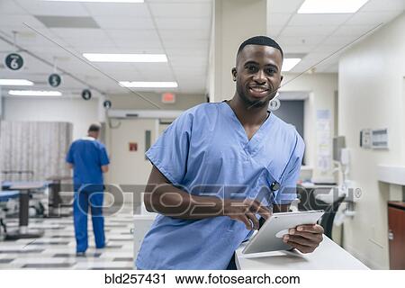 Portrait of smiling doctor using digital tablet in hospital View Large Photo Image Stock Image - Portrait of smiling doctor using digital tablet in hospital. Fotosearch