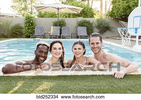 Picture - Portrait of smiling friends in swimming pool. Fotosearch