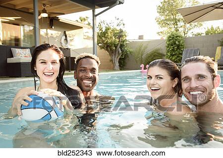 Portrait of smiling friends in swimming pool with basketball View Large Photo Image Stock Image - Portrait of smiling friends in swimming pool with basketball. Fotosearch