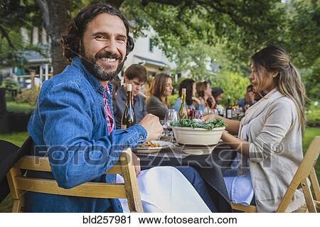 Portrait of smiling man at party outdoors View Large Photo Image Stock Image - Portrait of smiling man at party outdoors. Fotosearch