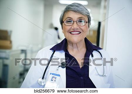 Stock Photo - Portrait of smiling mixed race doctor. Fotosearch