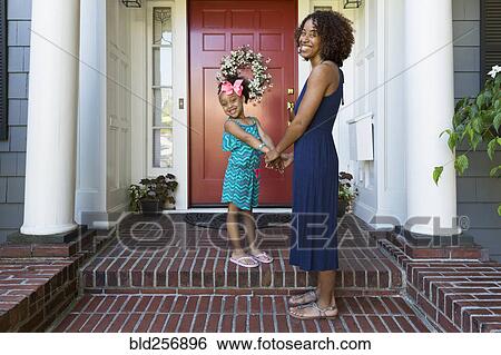 Portrait of smiling mixed race mother and daughter on front stoop View Large Photo Image Stock Photograph - Portrait of smiling mixed race mother and daughter on front stoop. Fotosearch