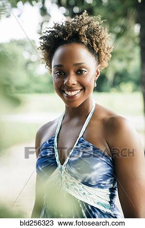 Portrait of smiling mixed race woman outdoors View Large Photo Image Stock Image - Portrait of smiling mixed race woman outdoors. Fotosearch