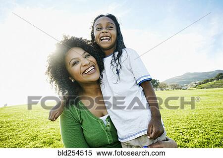 Stock Photography - Portrait of smiling mother and mixed race daughter. Fotosearch