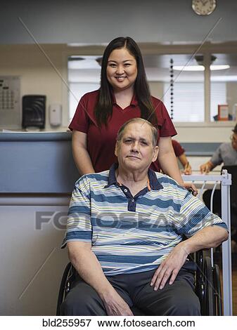 Portrait of smiling nurse and patient in wheelchair View Large Photo Image Stock Photo - Portrait of smiling nurse and patient in wheelchair. Fotosearch