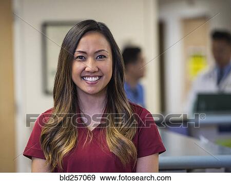 Portrait of smiling nurse in hospital View Large Photo Image Stock Photo - Portrait of smiling nurse in hospital. Fotosearch