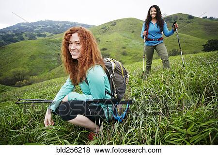 Portrait of smiling women hiking with walking sticks View Large Photo Image Stock Photo - Portrait of smiling women hiking with walking sticks. Fotosearch