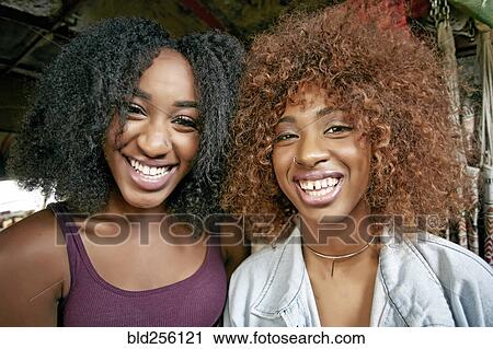 Stock Image - Portrait of smiling women. Fotosearch