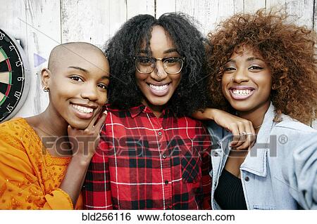 Stock Photograph - Portrait of smiling women. Fotosearch
