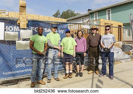 Stock Photograph - Portrait of volunteers at a construction site. Fotosearch
