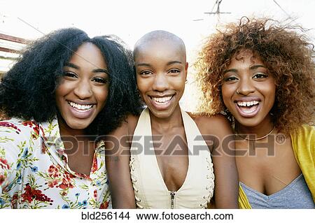 Picture - Portrait of women smiling outdoors. Fotosearch