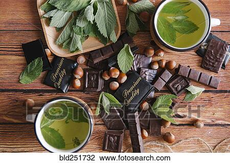 Stock Image - Premium quality chocolate near green tea. Fotosearch