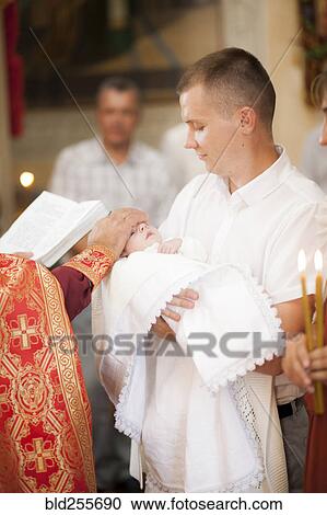 Priest blessing baby boy in church View Large Photo Image Stock Image - Priest blessing baby boy in church. Fotosearch