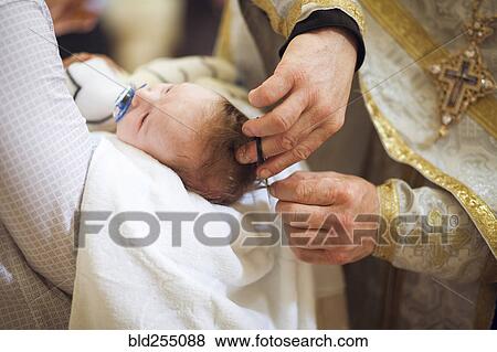 Priest clipping hair of baby girl View Large Photo Image Stock Photo - Priest clipping hair of baby girl. Fotosearch