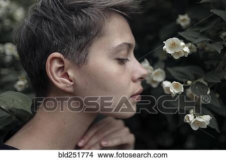 Profile of Caucasian woman smelling flowers View Large Photo Image Picture - Profile of Caucasian woman smelling flowers. Fotosearch