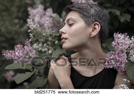 Stock Photography - Profile of Caucasian woman standing in flowers. Fotosearch