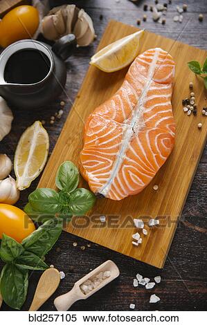 Raw salmon on cutting board with ingredients View Large Photo Image Stock Photography - Raw salmon on cutting board with ingredients. Fotosearch