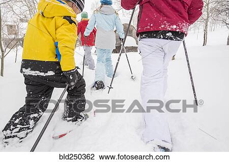 Rear view of Caucasian family snowshoeing View Large Photo Image Stock Image - Rear view of Caucasian family snowshoeing. Fotosearch
