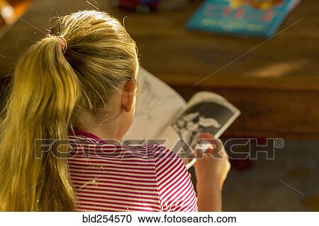 Rear view of Caucasian girl reading book View Large Photo Image Stock Image - Rear view of Caucasian girl reading book. Fotosearch