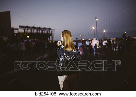 Rear view of Caucasian woman at night View Large Photo Image Stock Photo - Rear view of Caucasian woman at night. Fotosearch