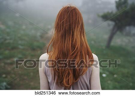 Rear view of Caucasian woman with red hair View Large Photo Image Stock Photograph - Rear view of Caucasian woman with red hair. Fotosearch