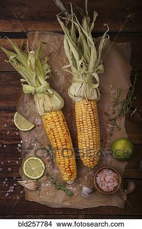 Roasted corn on the cob with lime and salt View Large Photo Image Picture - Roasted corn on the cob with lime and salt. Fotosearch