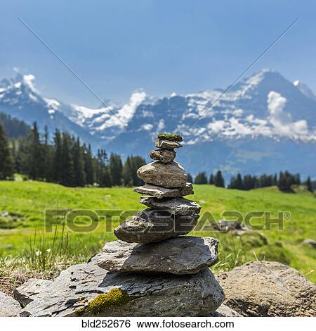 Rocks balancing in pile near mountains View Large Photo Image Stock Photograph - Rocks balancing in pile near mountains. Fotosearch