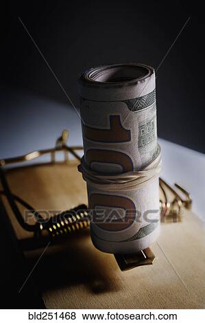 Roll of money in mouse trap View Large Photo Image Stock Photo - Roll of money in mouse trap. Fotosearch