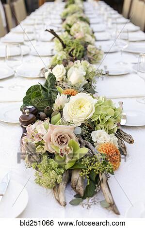 Row of flowers on table View Large Photo Image Stock Photograph - Row of flowers on table. Fotosearch