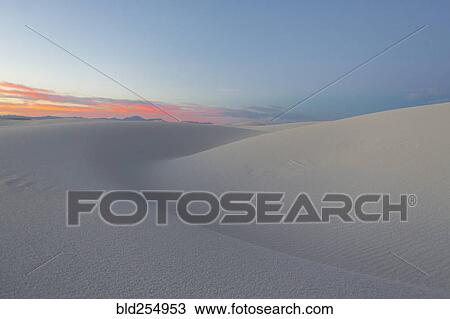 Stock Image - Sand dunes in desert at sunset. Fotosearch