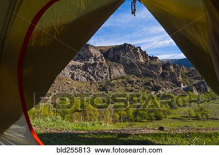 Stock Image - Scenic view of mountain from inside tent. Fotosearch