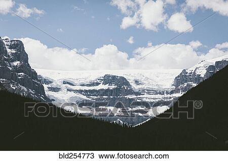 Stock Image - Scenic view of snow on mountain range. Fotosearch