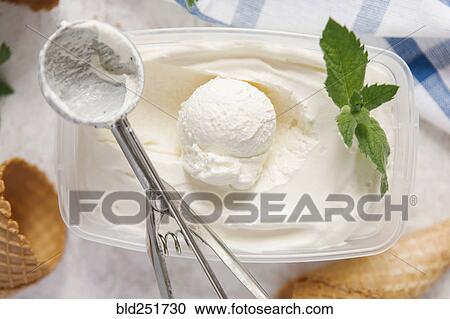 Scoop of ice cream in container with mint near cones View Large Photo Image Stock Image - Scoop of ice cream in container with mint near cones. Fotosearch