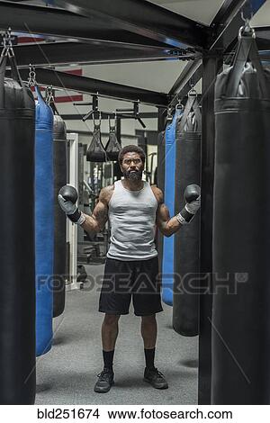 Serious black boxer posing in gymnasium View Large Photo Image Picture - Serious black boxer posing in gymnasium. Fotosearch